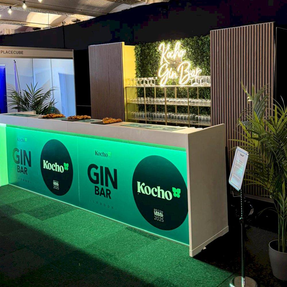White modular bars complete with lighting against our Aluvision walnut slatted panels and green living wall. Hire this setup today.