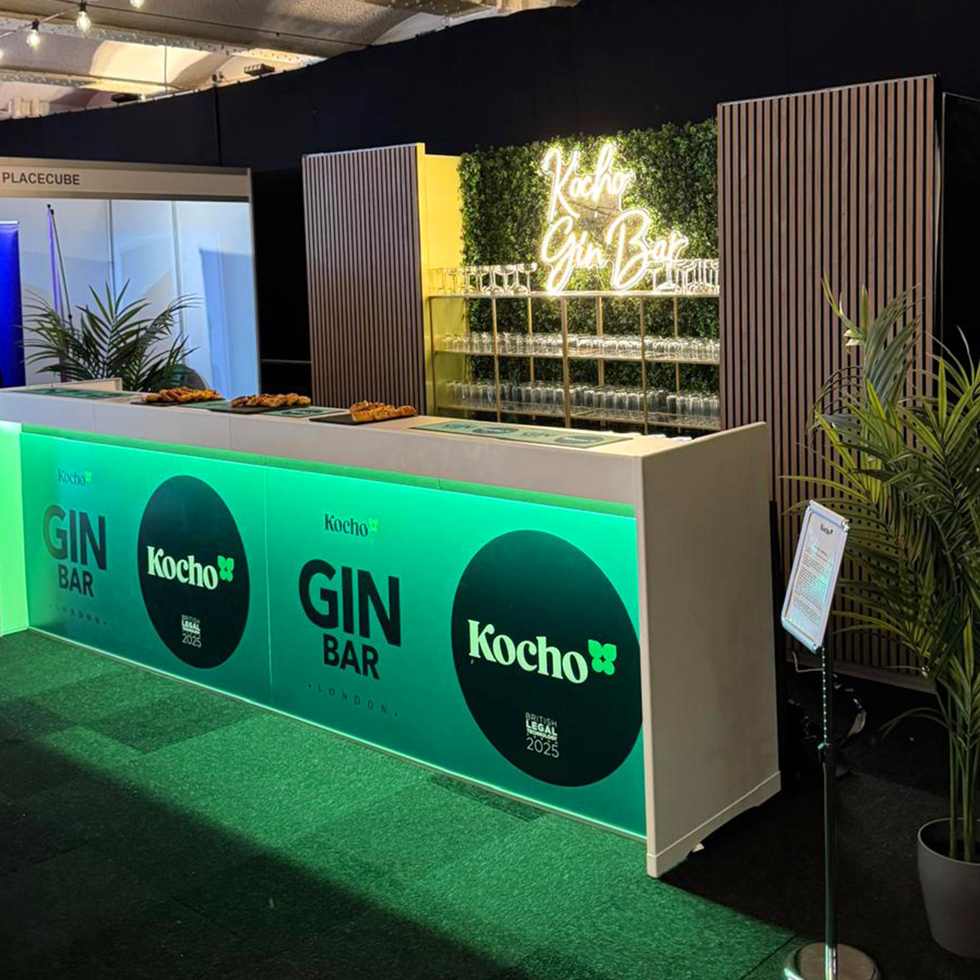 White modular bars complete with lighting against our Aluvision walnut slatted panels and green living wall. Hire this setup today.
