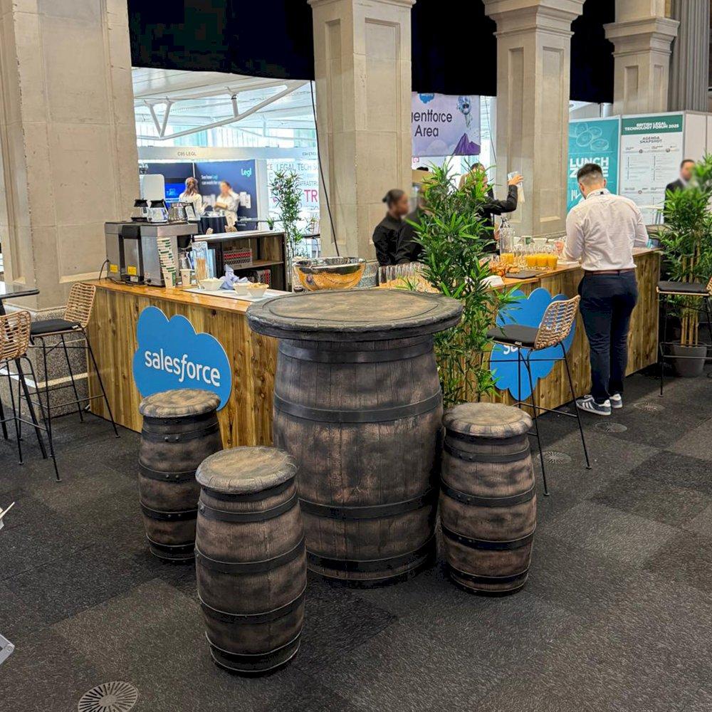 Rustic bar hire with barrel tables and matching stools.